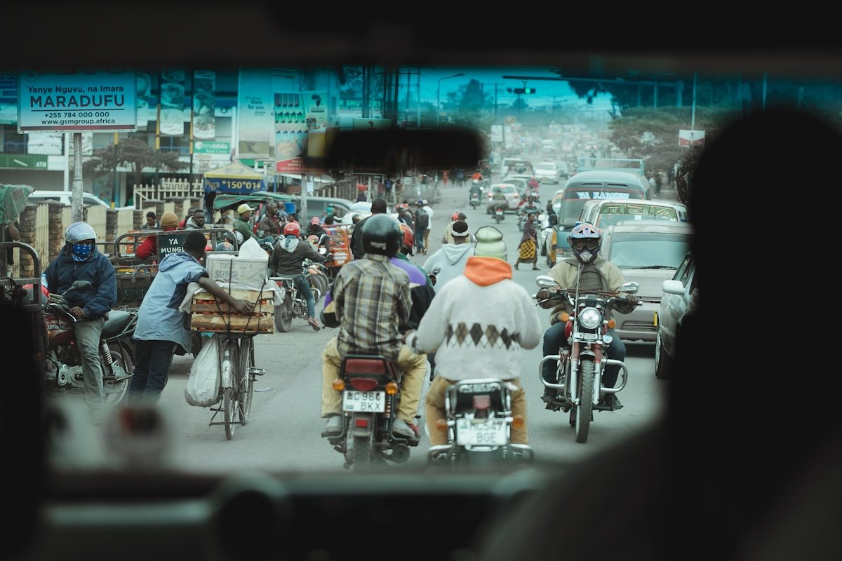Busy street scene with motorcycles and vendors in central Arusha, Tanzania