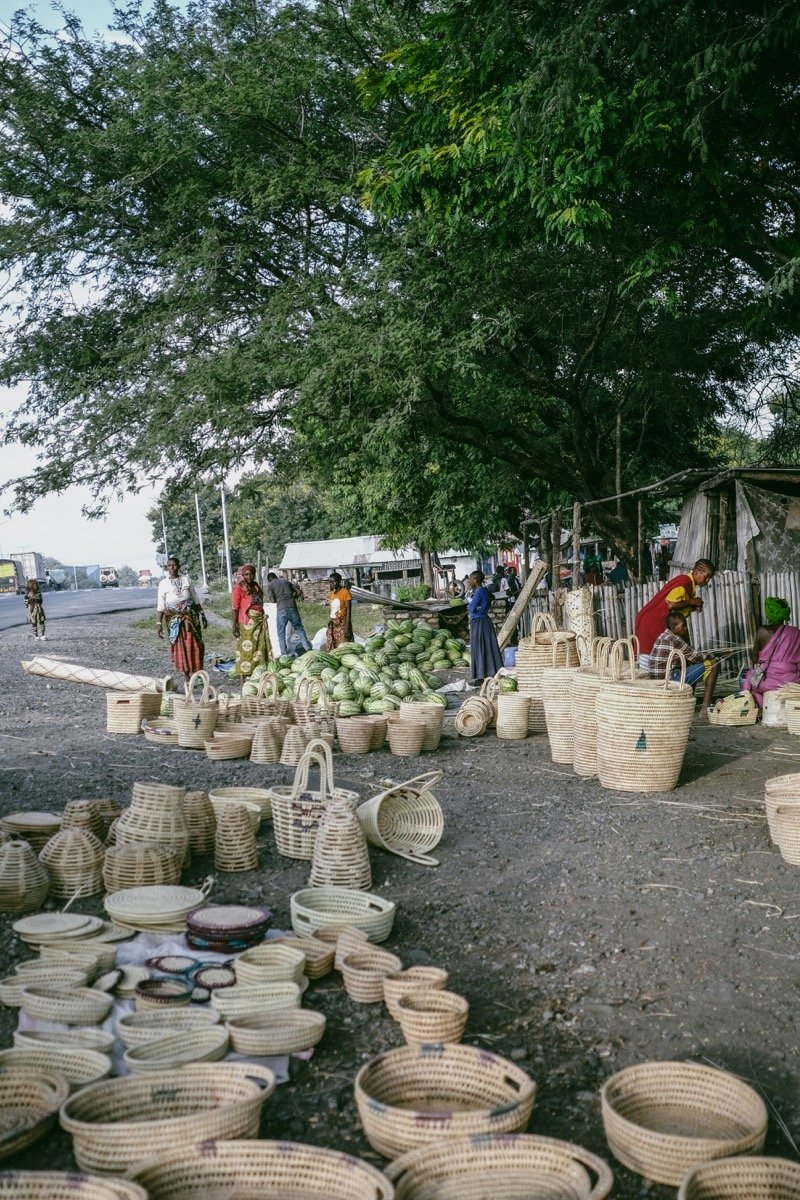 Outdoor market with woven baskets and fresh produce in Arusha, Tanzania