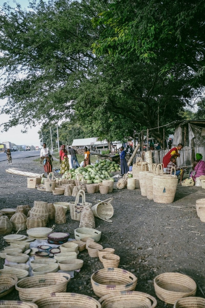 Outdoor market with woven baskets and fresh produce in Arusha, Tanzania