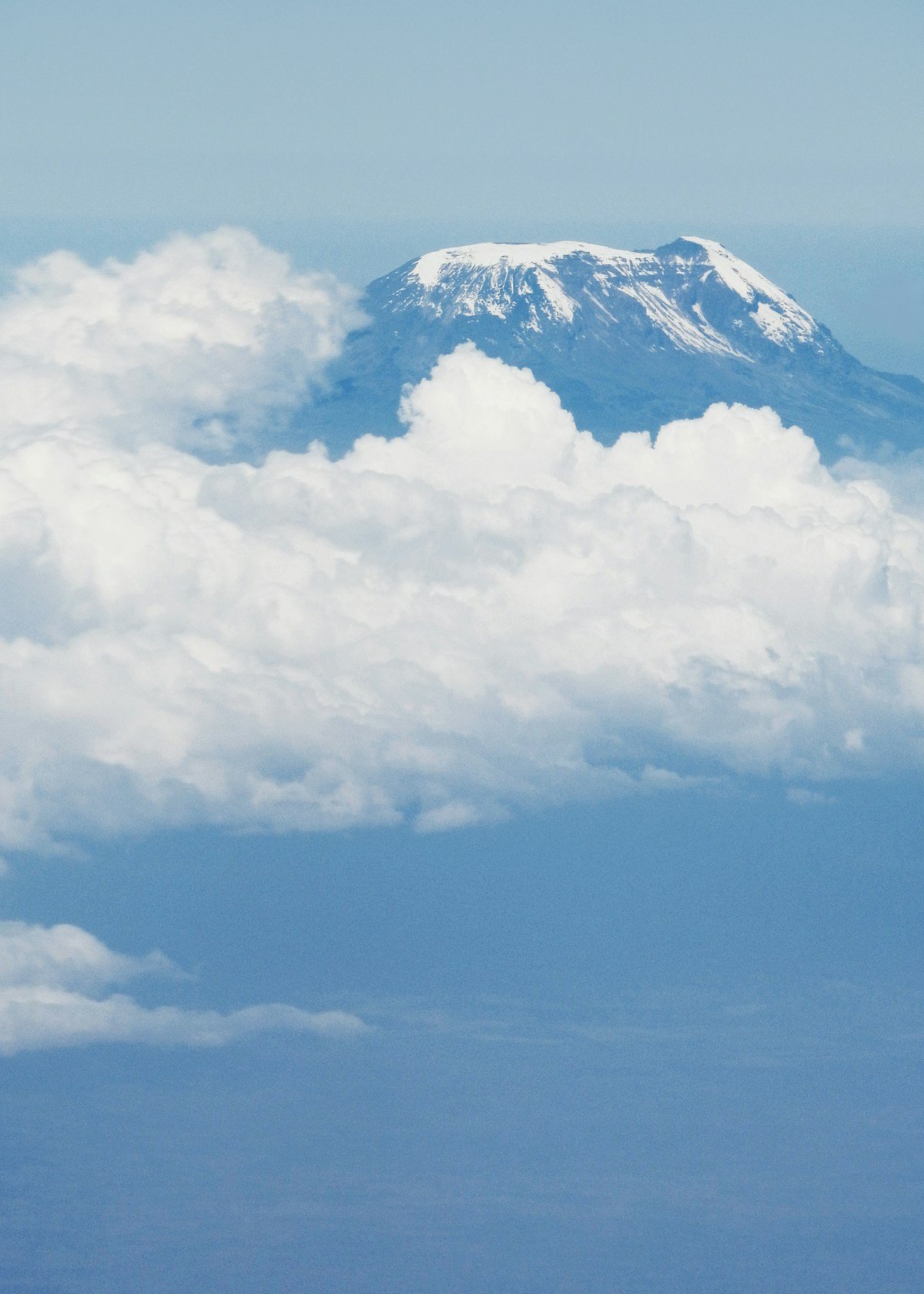 Snow-capped peak of Kilimanjaro rising above the clouds, Tanzania