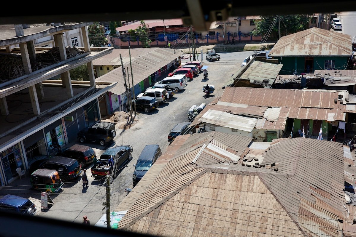 Street view of a Tanzanian town with cars and low-rise buildings, East Africa