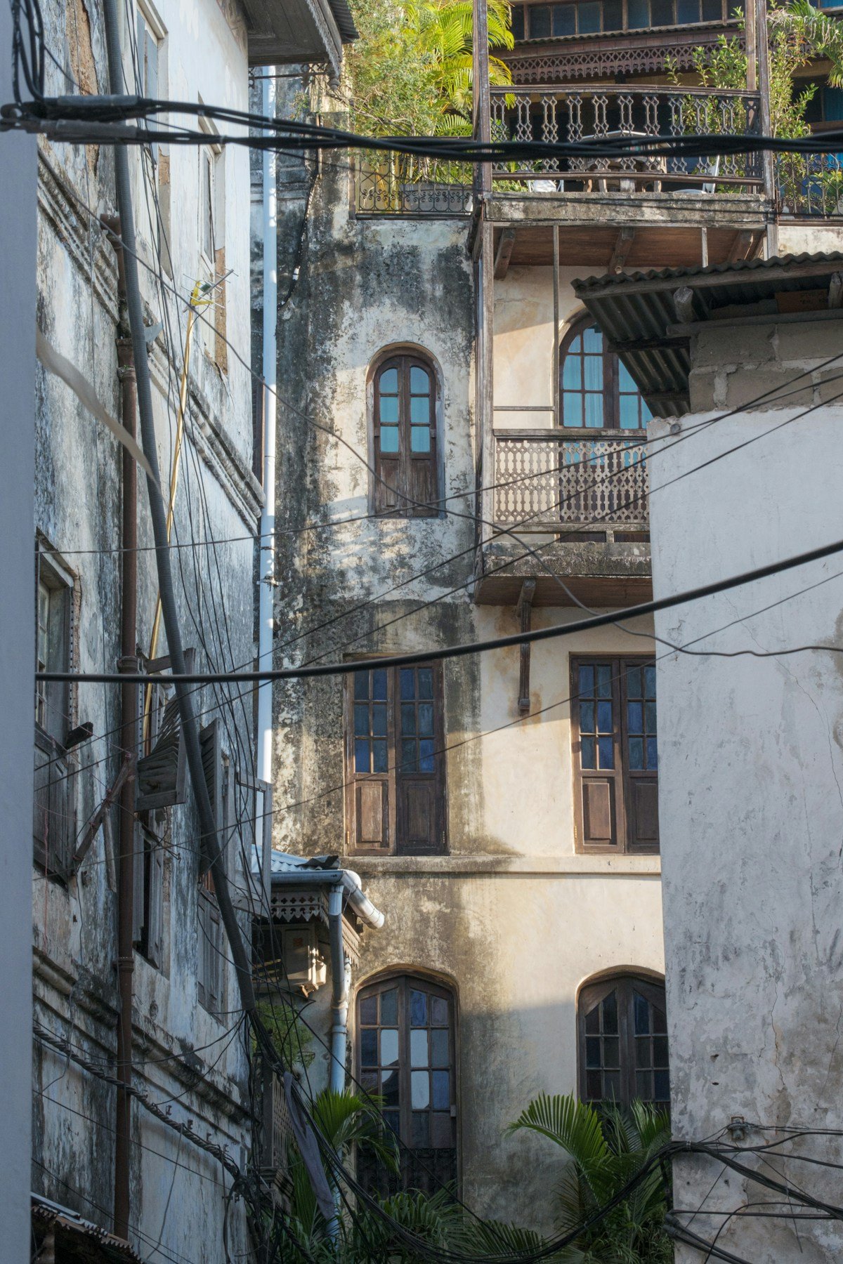 Historic coral stone buildings with carved wooden balconies in Stone Town, Zanzibar
