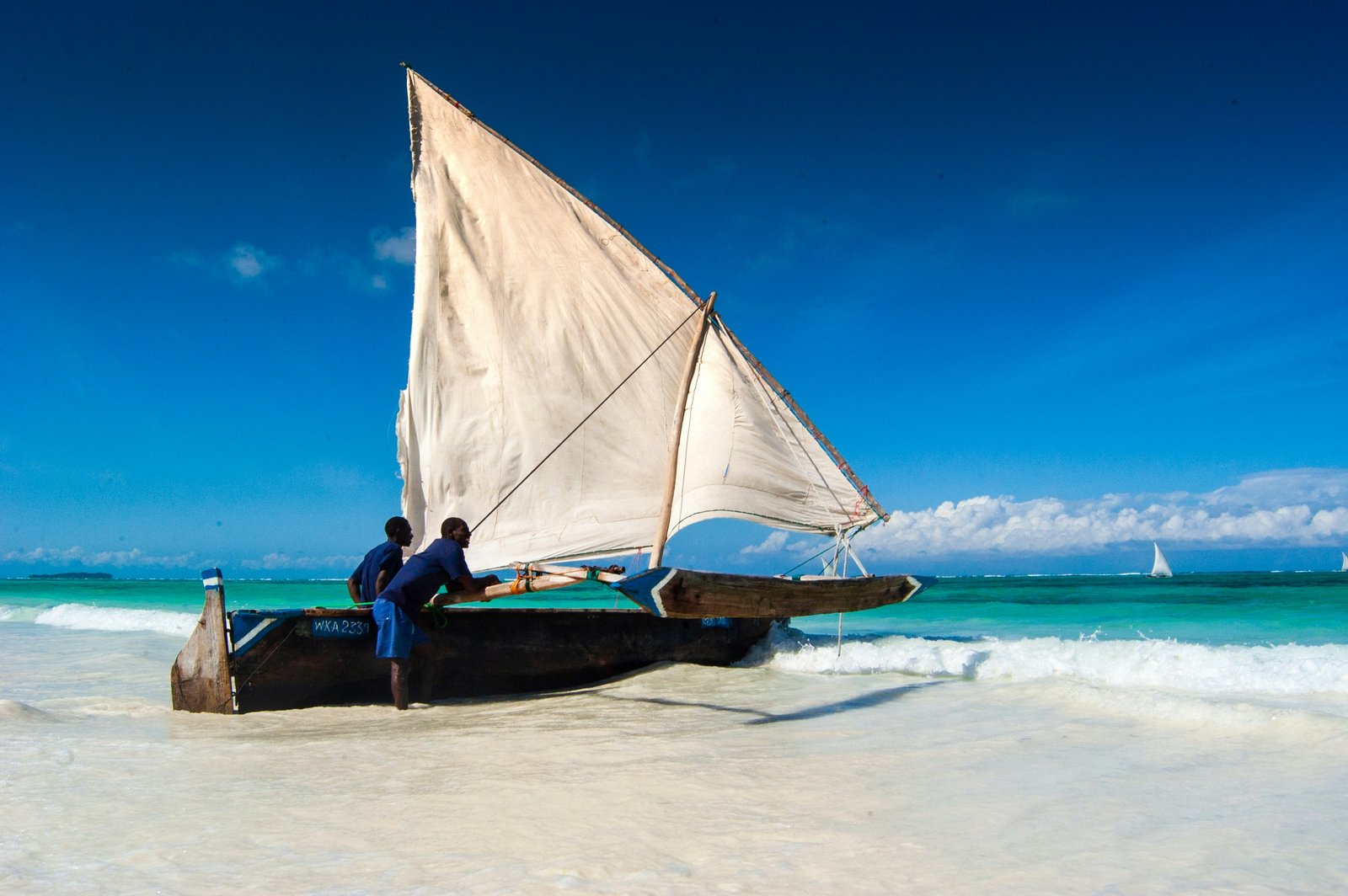 Traditional dhow sailing boat on the turquoise waters off Zanzibar, Tanzania