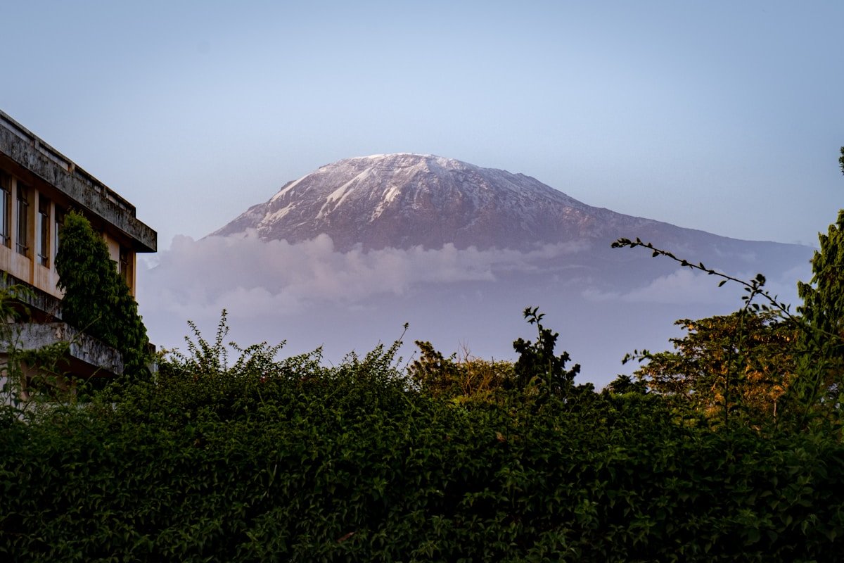 View of Kilimanjaro's snow-capped summit emerging through cloud from the town of Moshi, Tanzania
