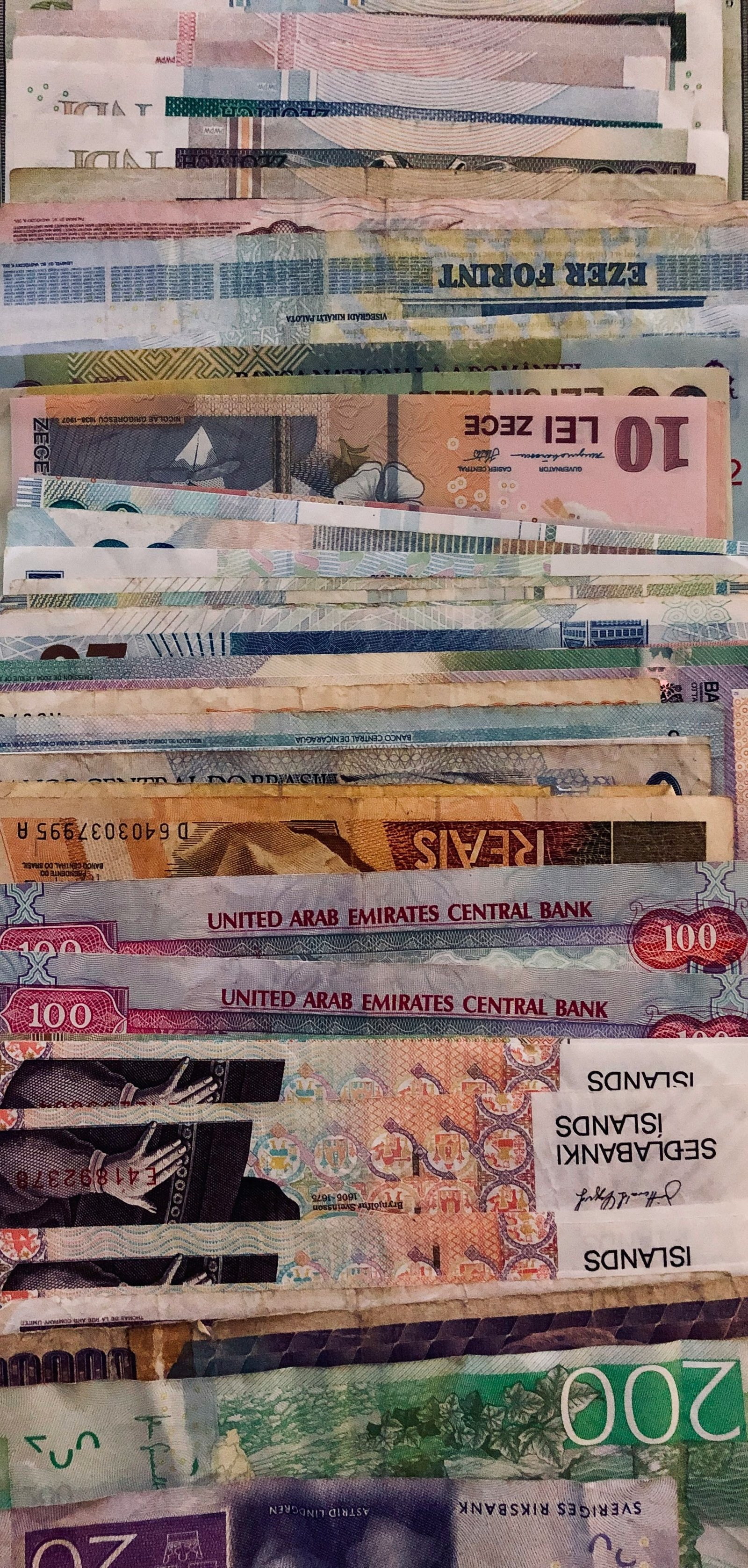 Collection of international banknotes fanned out, representing currency exchange