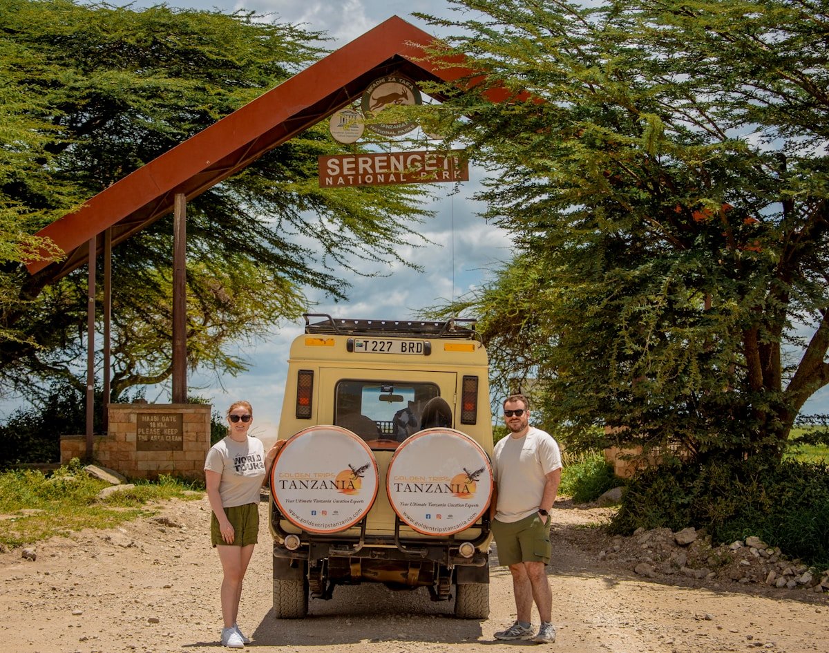 Safari vehicle at the Serengeti National Park entrance — Tanzania travel coverage is essential