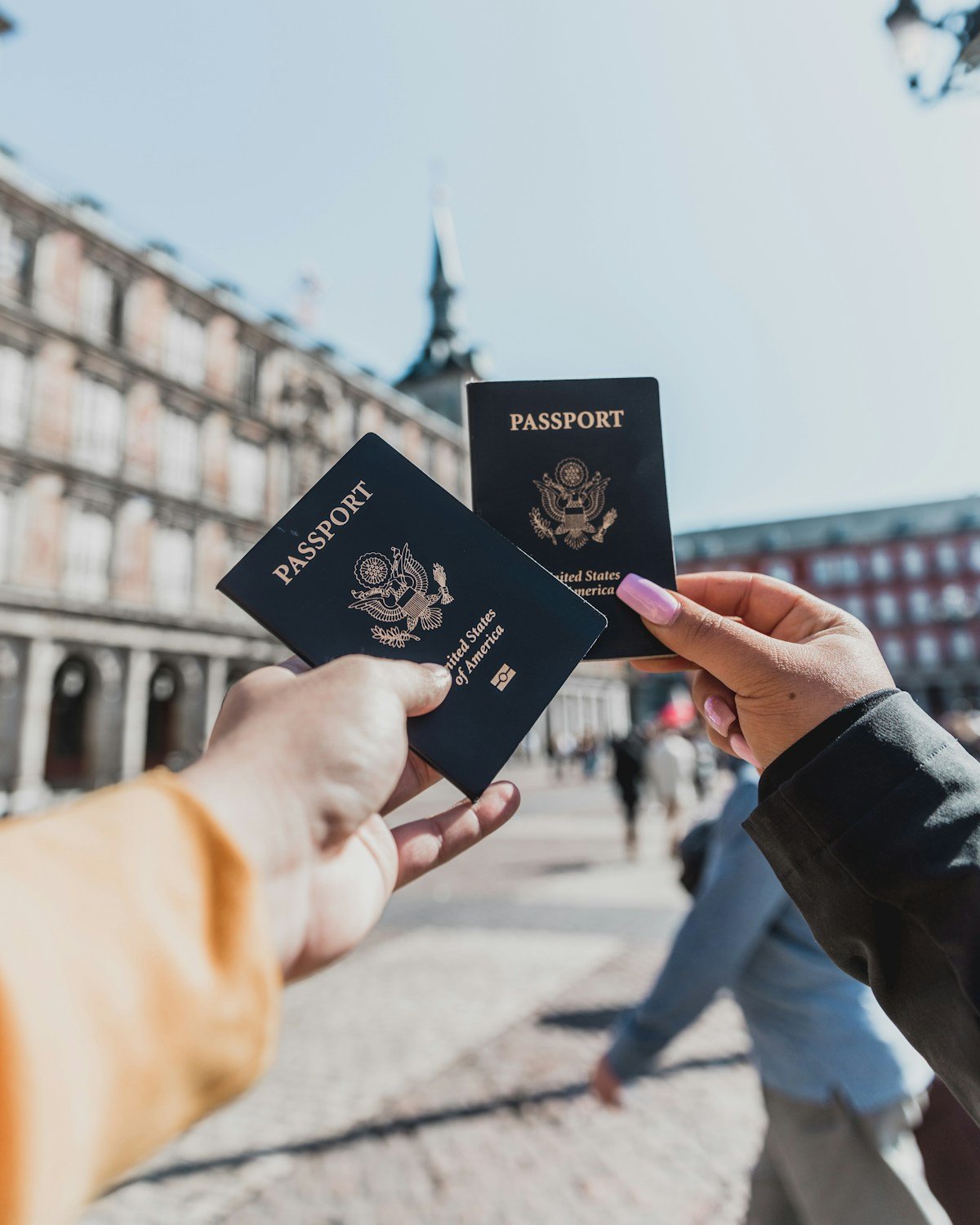Two people holding passports — Tanzania visa and entry documents