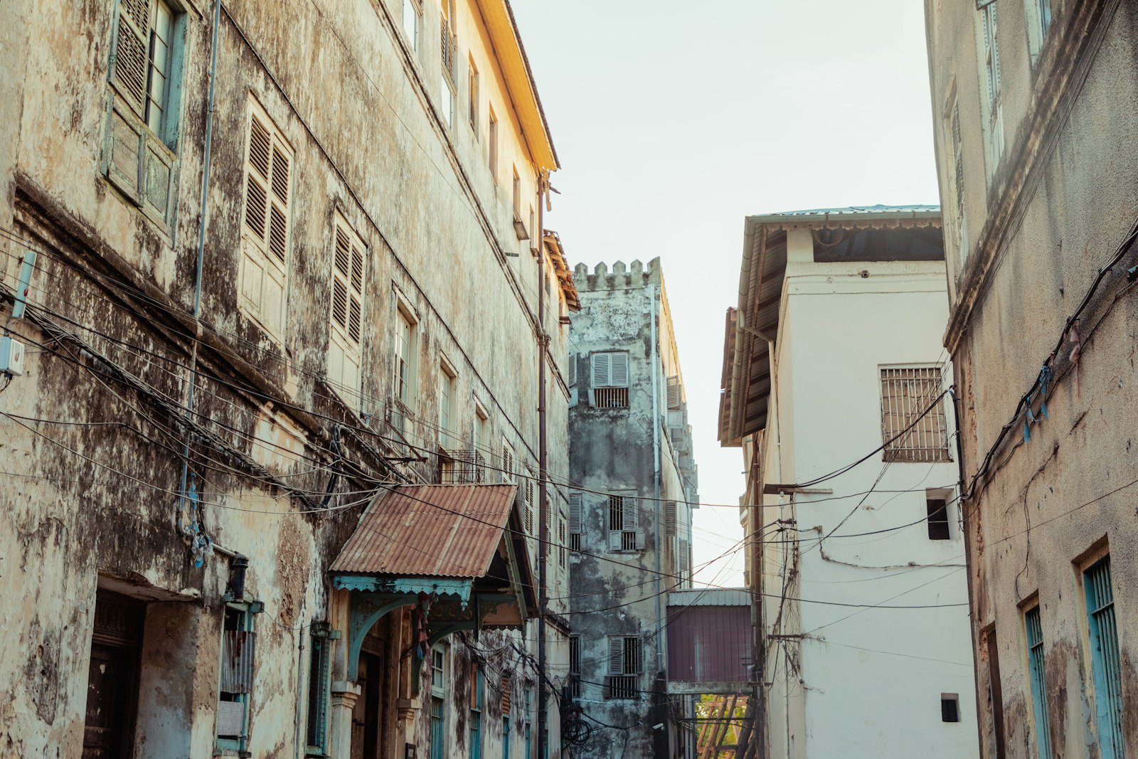 Narrow alley between historic stone buildings in Stone Town, Zanzibar